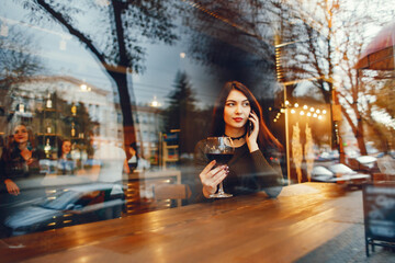 Beautiful girl holding a glass of vine