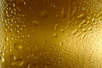 Blurred background the color of old gold with drops of water.