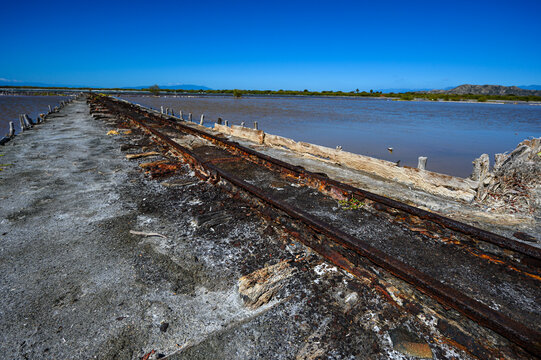 Rusty railway on lakes for salt mining in the south of the Dominican Republic. The photo. Wide angle, Copy space, High quality photo