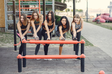 Sports girls training in a summer park