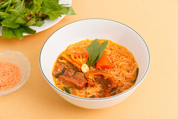 Hu tieu bo kho, Vietnamese Beef Stew with rice noodles, Vietnamese food isolated on beige background, close-up