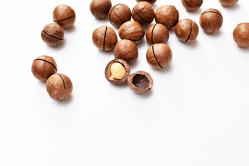 a scattering of macadamia nuts on a white background