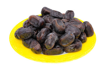 Delicious dried dates on a yellow plate isolated on a white background