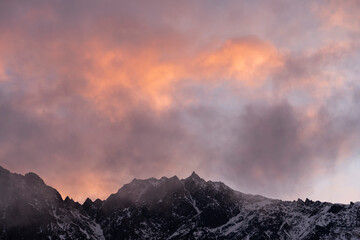 Beautiful winter mountains landscape on the sunrise. High snow covered mountains in the fog. Georgia, Kazbegi.