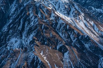 Close up snow covered mountains. Nature mountains texture.