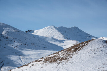 Fototapeta na wymiar High snow covered mountains. Winter mountains landscape.