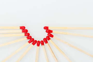 matchstick with a red heart-shaped head on a white background