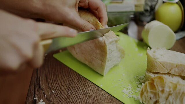Woman trying to cut bread with a dull knife, blunt blade