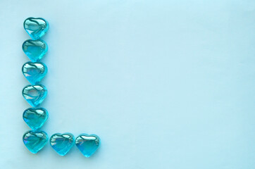 Glass hearts on a blue background. Valentine's day greeting, wedding and invitation concept.
