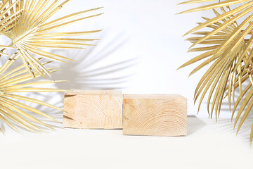 Abstract background with natural wooden podiums and golden palm leaves, empty showcase for showcase...