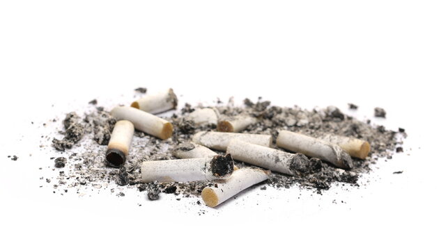Cigarette stubs in ash pile isolated on white 