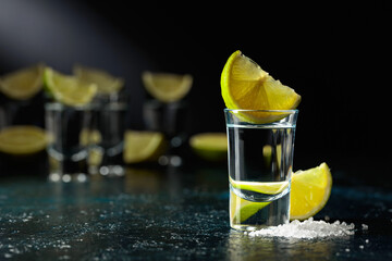 Tequila shots with lime slices and sea salt.