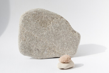 Grey stones on a white background. Natural display with copy space