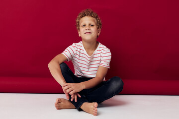 boy on the floor wearing a t-shirt posing Studio