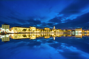 Riva promenade with Diocletian Palace with reflection at dawn. Split, Croatia