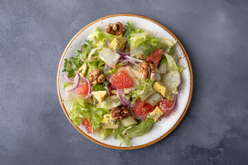 Healthy salad with grapefruit, walnuts and cheese. Top view