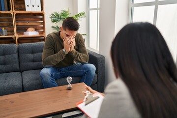 Man and woman having psychology session at clinic