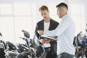 Handsome man choosing a motorcycle to buy