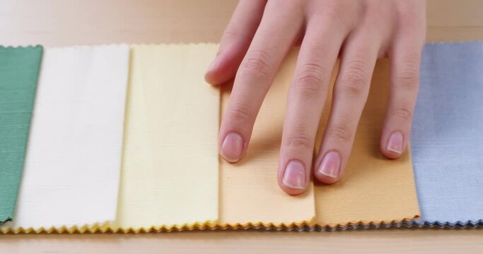 Colorful fabric samples close-up. Different colourful swatches selection, pastel shades palette. Macro shooting of textile texture. Tailoring and sewing concept.