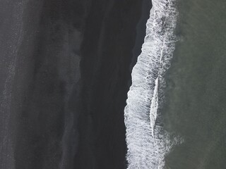Aerial drone landscape of black sand beach waves in Vik south Iceland