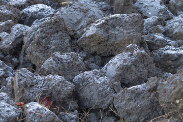 Close up shot of plowed land a thin layer of frost on it