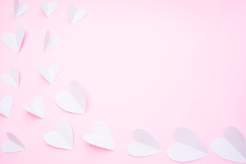 White paper hearts on pink background for Happy Valentine's Day. Happy mother's day