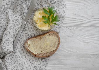 bread with butter on a wooden background