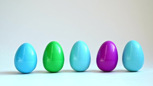 Colorful Easter eggs stand in a row swinging.