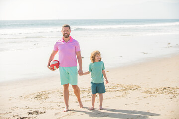 Naklejka premium kid and dad walking on beach in summer vacation holding ball, summer