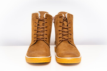 brown leather winter boots with lacing on a white background