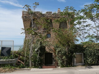 ruins of an old tower along the promenade of Termoli with the sea in the background