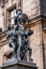 Fototapeta na wymiar Classical bronze sculpture with victor holding a wreath and kids around him, the old town of Dresden, Germany