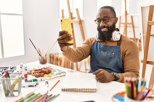 Young african american artist man making selfie by the smartphone at art studio.
