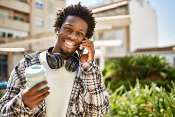 Handsome black man with afro hair having a conversation speaking on the phone