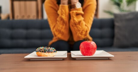 Young latin woman patient stressed asking for eating disorder at clinic