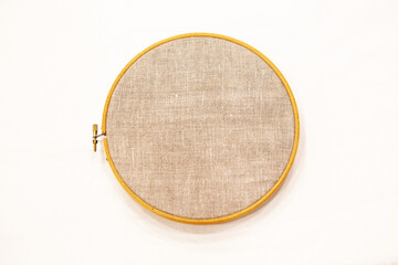 Embroidery hoop with natural linen fabric, as a template.