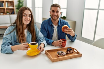 Young caucasian couple having breakfast at home.