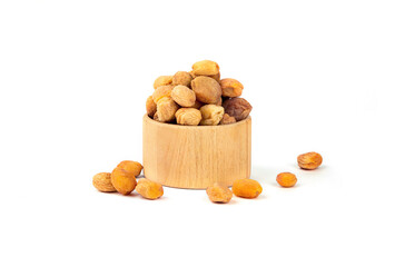 Dried apricot with a bone in a wooden round shape on a white background
