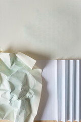 crumpled, flat, and folded paper with ink stains