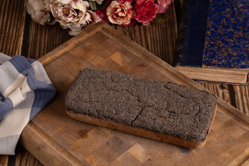 Rustic bread on a cutting board with flowers