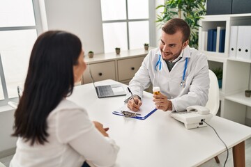 Man and woman doctor and patient having medical consultation prescribe pills at clinic