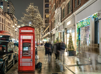 Red telephone booth turned into cash machine in London in Christmas time