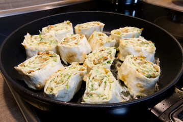Snack roll of pita on a frying pan. close up