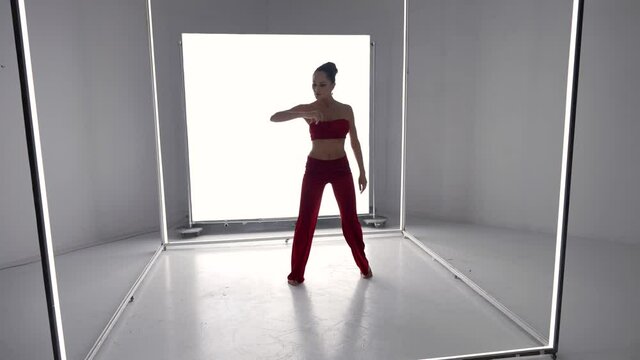 Modern Dance Of Sexy Young Woman, Brunette Lady In Red Suit Is Dancing Alone In Room