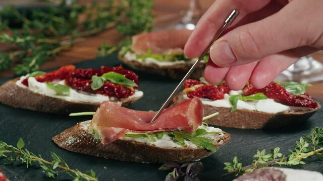 Italian restaurant with traditional food, Spanish cuisine, delicious tapas and white wine, bruschetta with cheese, olives dry tomatoes and tasty sandwich bar appetizer, buffet high cuisine table