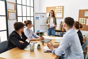 Group of young business workers listening boss conference during meeting at the office.
