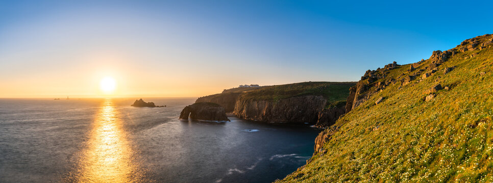 Land's End with Enys Dodman arch at sunset, Cornwall. United Kingdom