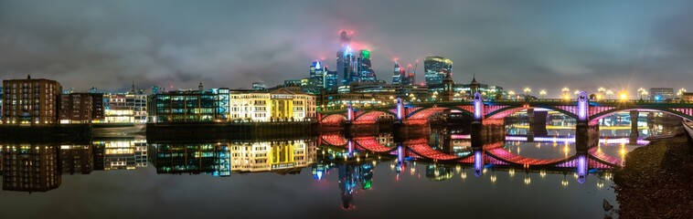 Obraz premium Panorama of Southwark bridge and financial district of London at night. England