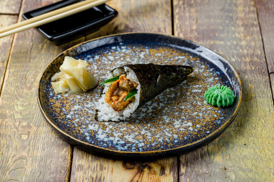 hand roll with eel on wooden table