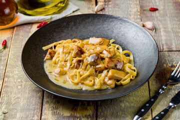 fettuccine with porcini mushrooms on wooden table